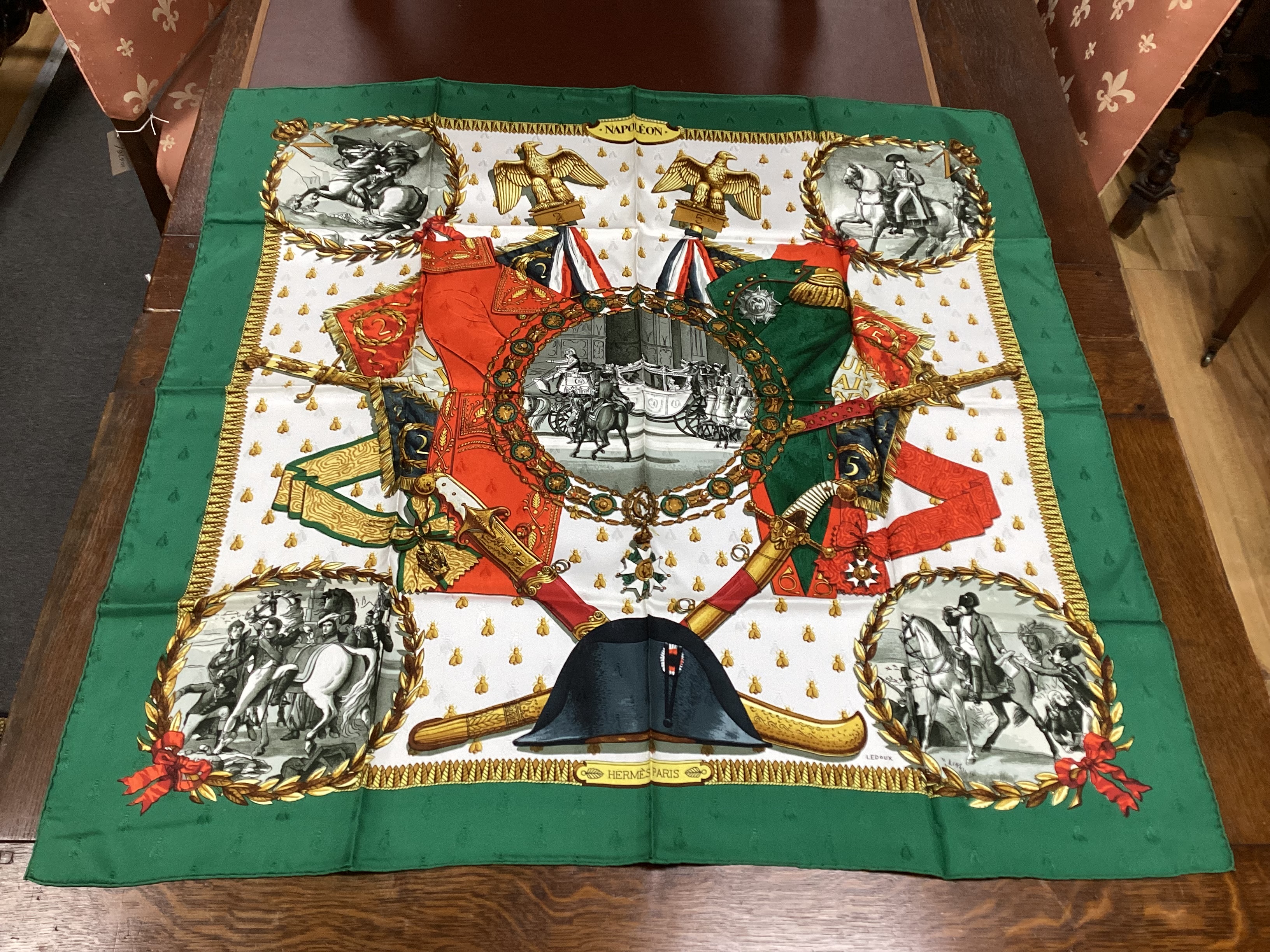 Four vintage Hermes silk scarves including two retailed by Harrods comprising Cuivreries, Roues de Canon, Napoleon and Puzzle